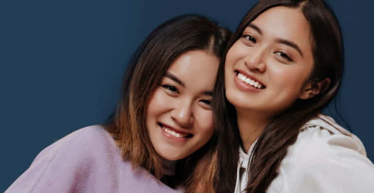Two young women smiling together