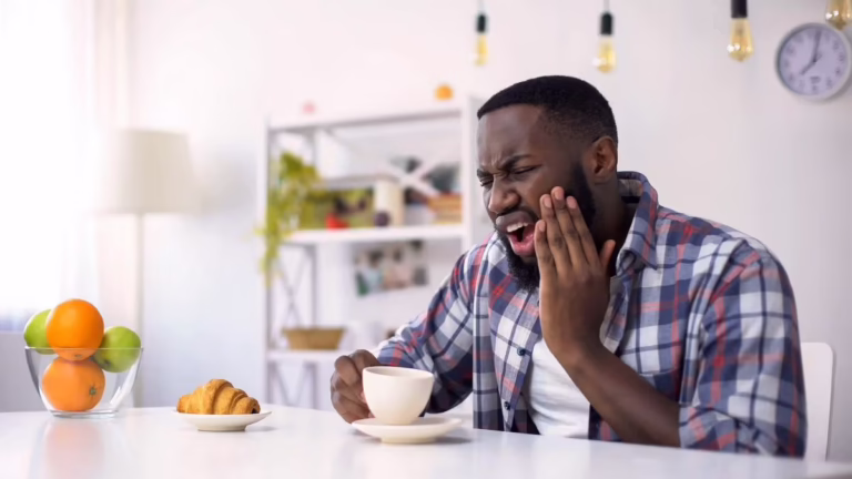 Man touching his jaw in discomfort